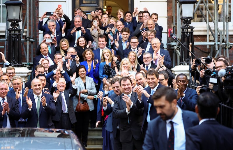 Conservative MPs applaud as Rishi Sunak arrives. Reuters