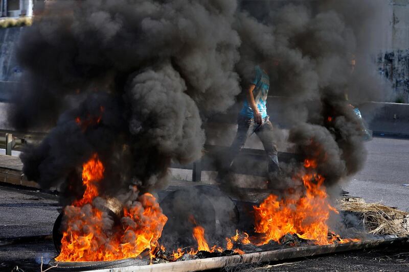 Protesters burn tires to close the main highways during ongoing protests against the government, in Khaldeh, Lebanon. AP Photo