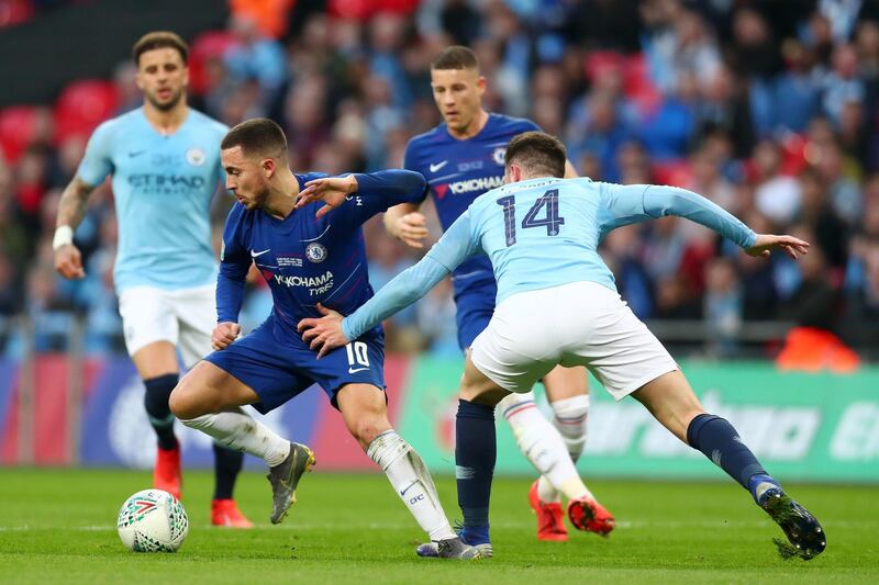 Hazard runs with the ball under pressure from Aymeric Laporte of Manchester City. Getty Images