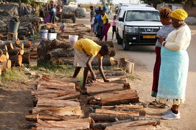 epa07586967 Women buy firewood in Tafara, Zimbabwe, 18 May 2019 (issued 20 May 2019) as power cuts continue. The Zimbabwe Electricity Transmission and Distribution Company (ZETDC), citing reduced output at its largest hydro plant and ageing coal-fired generators, said power cuts which started a week now would last up to eight hours during morning and evening peak periods. This has led to massive disruption of production and has also led to a huge demand of firewood and liquid petroleum gas.  EPA/AARON UFUMELI