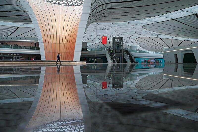 A worker walks inside the terminal hall of the Beijing Daxing International Airport.  Reuters