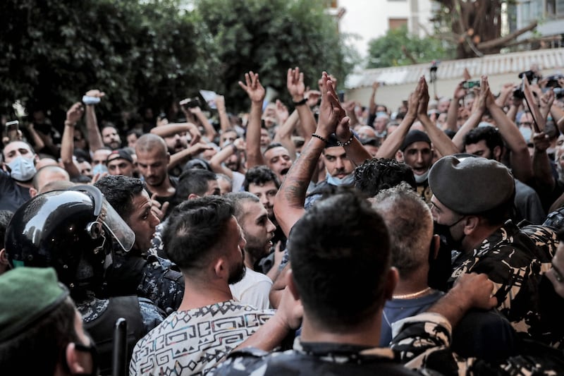 Demonstrators and families of the Beirut blast victims chant slogans during a protest outside the residence of Lebanon's interior minister in the Qoraitem neighbourhood of western Beirut.