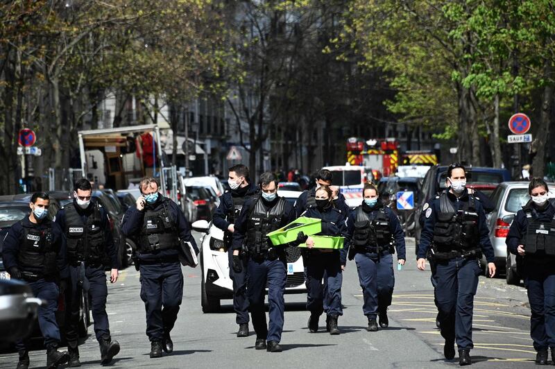Police officers leave the scene of a shooting outside the Henry Dunant private hospital in Paris. AFP