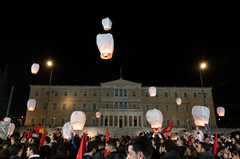 Demonstrators release lanterns during a protest in front of the parliament, in Athens. AP