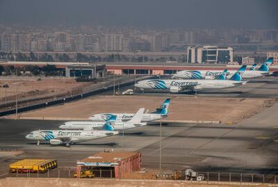 A photo taken on January 6, 2021 shows Egypt air planes at Cairo airport's tarmak. Egypt reopened its airspace to Qatari flights on January 18 following a thaw in relations between Doha and a Saudi-led bloc. Egypt in June 2017 joined Saudi Arabia, the United Arab Emirates and Bahrain in cutting ties with Qatar, accusing it of being too close to Iran and backing the Muslim Brotherhood, seen by Cairo and its Gulf allies as a "terrorist" group. Qatar has denied the charges. / AFP / Khaled DESOUKI
