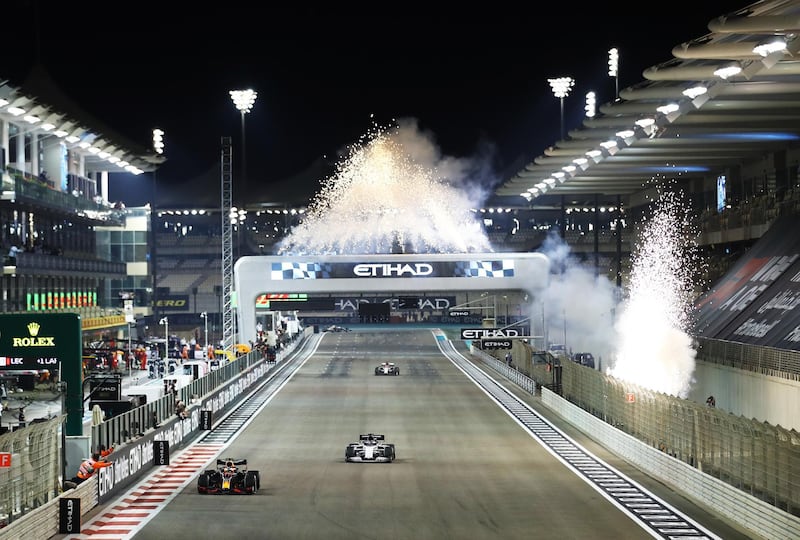 Fireworks go off as Max Verstappen crosses the line to win the race. Getty