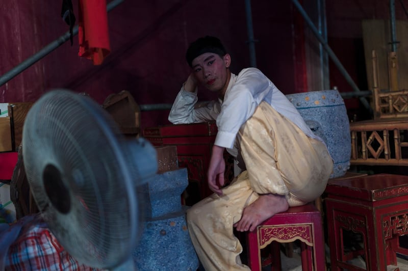 A Chiu Chow opera performer sits in the backstage during a performance. EPA