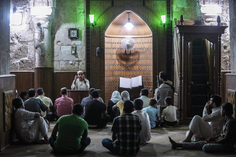 An imam gives a sermon before Muslim worshippers attending at a mosque in Maaret al-Noman in Syria's northwestern Idlib province lateon the occasion of Lailat al-Qadr. AFP