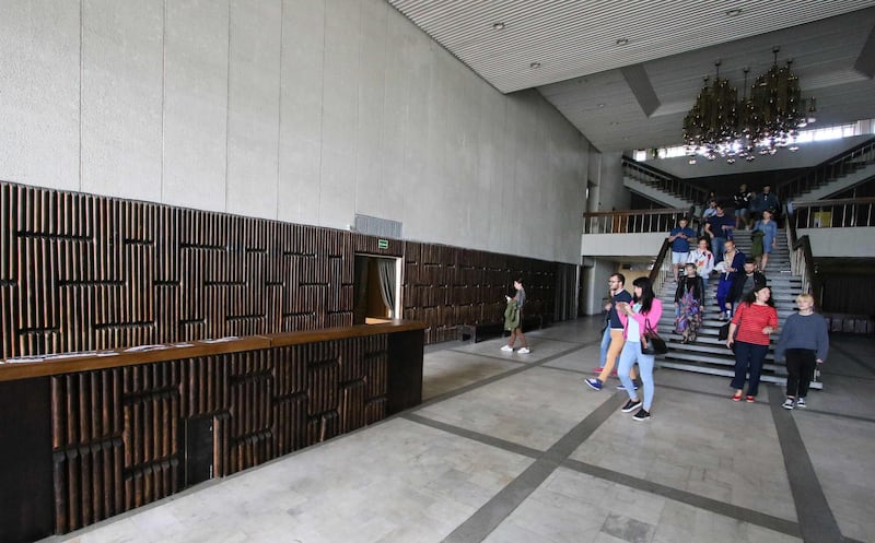 People walk inside the Former cultural and sports centre of the Ministry of the Interior.