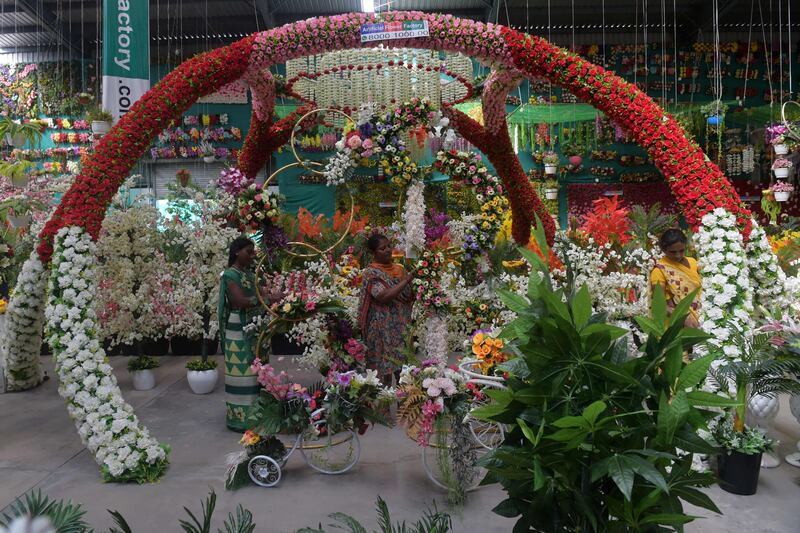 Women work inside an artifical flower shop in Ahmedabad. AFP