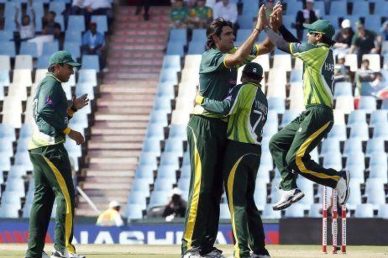 Pakistan players celebrate the dismissal of South Africa's Hashim Amla.