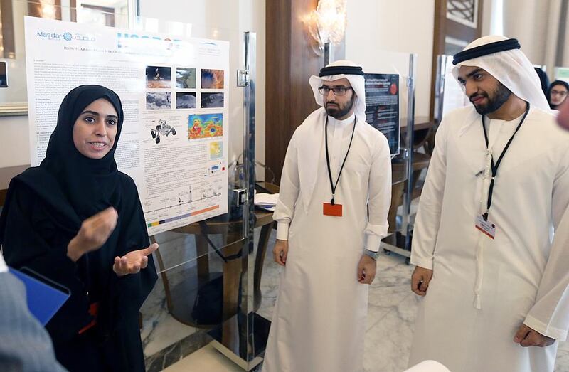 From left, Manar Al Mazrouei, Abdullah Sharif and Adham Al Khaja of the Masdar Institute of Science and Technology talk about their project during the Emirates Mars Mission Workshop in Dubai. Satish Kumar / The National