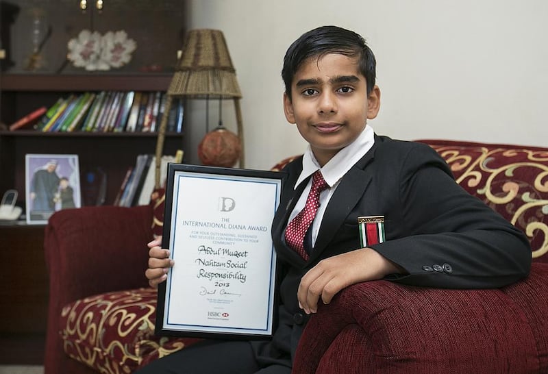 Indian Abdul Muqeet, 12, with his International Diana Award, signed by the prime minister of Britain, David Cameron. The schoolboy was honoured for his environmental work and innovative green thinking. Mona Al Marzooqi / The National 
