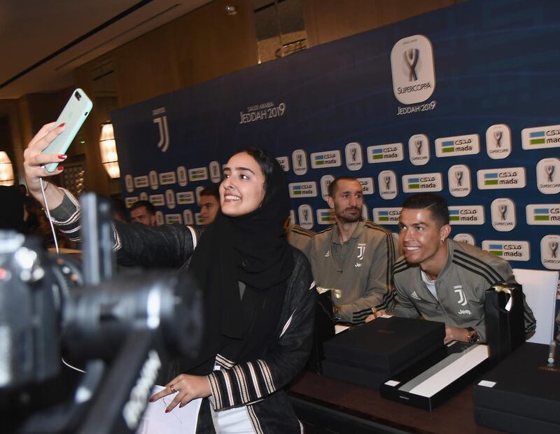 A Saudi fan takes a selfie with Cristiano Ronaldo. Getty Images