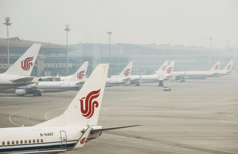 (FILES) This file photo taken on April 6, 2017 shows Air China planes parked at the Beijing Capital International Airport. An Air China jet made a rapid emergency descent after a co-pilot mistakenly turned off air-conditioning systems in a bid to conceal his e-cigarette smoke, Chinese media quoted the country's civil aviation authority as saying on July 13, 2018. - 
 / AFP / WANG ZHAO
