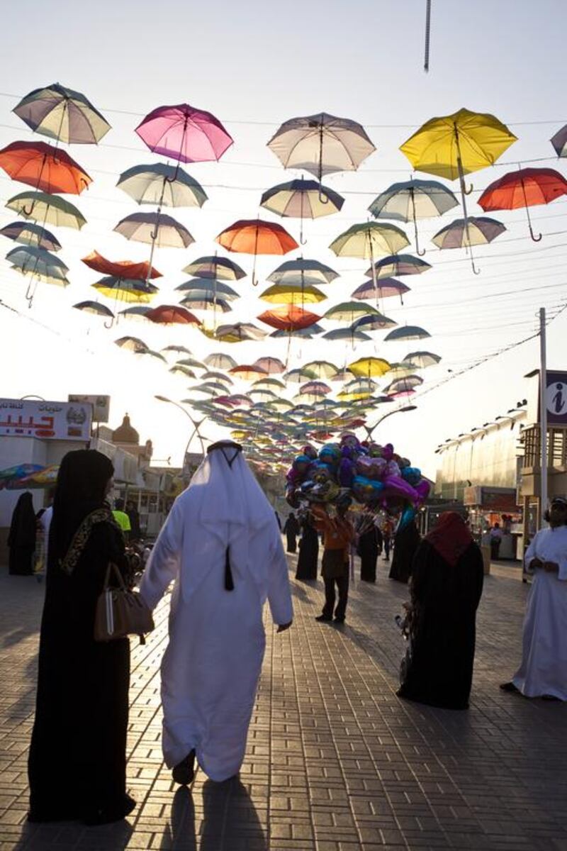 Visitors attend Global Village around dusk. This is Global Village's 18th season and has seen a record-breaking number of people. Razan Alzayani / The National