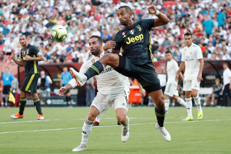Juventus' Medhi Benatia leaps to control the ball in front of Real Madrid's Dani Carvajal. Reuters