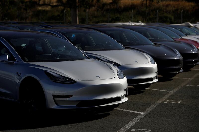 FILE PHOTO: A row of new Tesla Model 3 electric vehicles is seen at a parking lot in Richmond, California, U.S. June 22, 2018.  REUTERS/Stephen Lam/File Photo