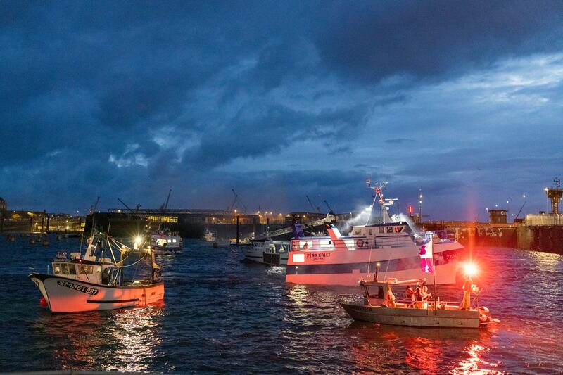 French fishing boats light flares and block the entrance to the port of Saint-Malo, in western France. AP