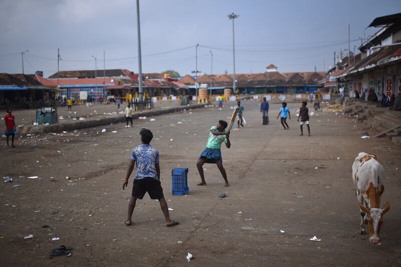 People play cricket at a closed marketplace in Chennai, India. The Tamil Nadu state government has imposed a weekend lockdown and announced new restrictions to fight a surge in coronavirus cases caused by the Omicron variant. EPA