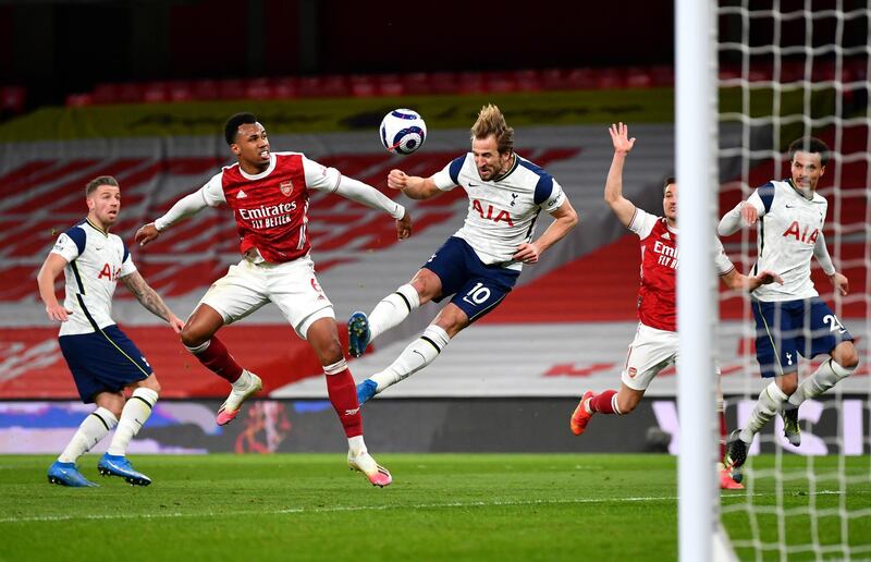 LONDON, ENGLAND - MARCH 14: Harry Kane of Tottenham Hotspur scores their side's second goal whilst under pressure from Gabriel Magalhaes of Arsenal which is disallowed for offside during the Premier League match between Arsenal and Tottenham Hotspur at Emirates Stadium on March 14, 2021 in London, England. Sporting stadiums around the UK remain under strict restrictions due to the Coronavirus Pandemic as Government social distancing laws prohibit fans inside venues resulting in games being played behind closed doors. (Photo by Dan Mullan/Getty Images)