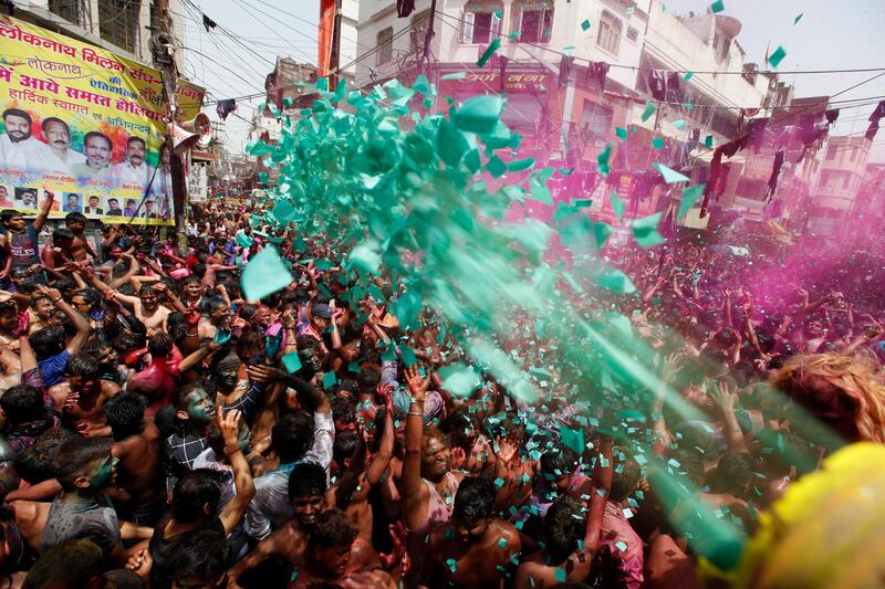 Hindu devotees throw coloured powder and dance as they celebrate the Indian festival of Holi in Loknath Prayagraj, India. AP