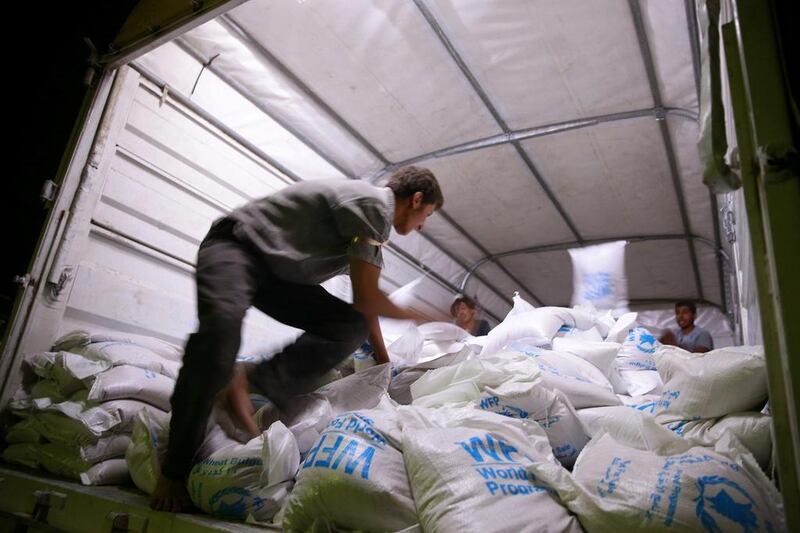 A Red Crescent and United Nations aid convoy carries food aid in the rebel held besieged town of Douma, Syria. Bassam Khabieh / Reuters