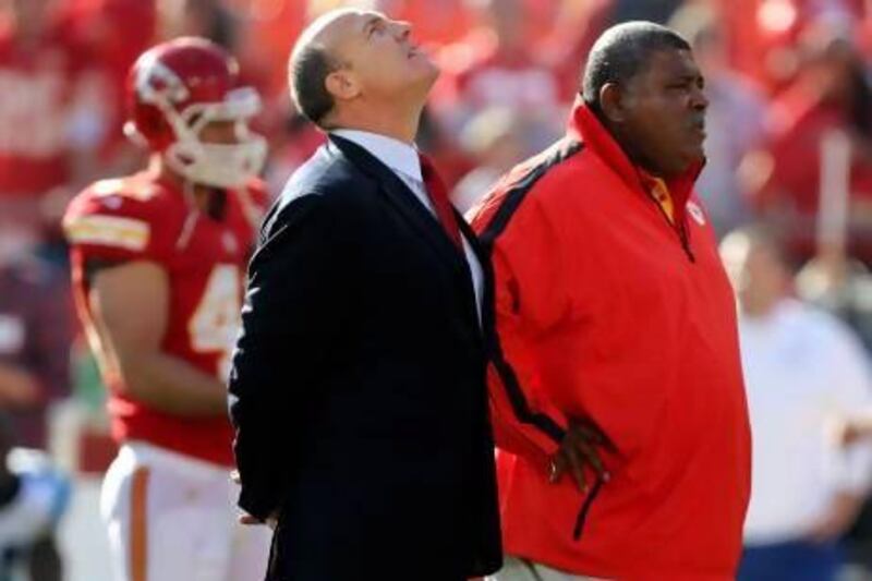 Scott Pioli, Kansas City Chiefs general manager, left, and coach Romeo Crennel stand together before last night's NFL match against the Carolina Panthers at Arrowhead Stadium in Kansas City. The staging of the game divided opinion after the suicide of Chiefs player Jovan Belcher. Ed Zurga / AP Photo