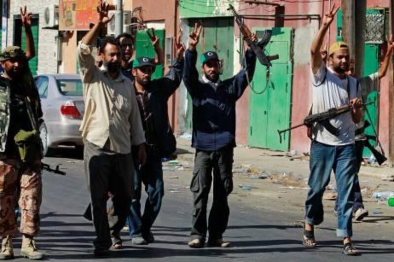 Rebel fighters celebrate after taking partial control of the coastal town of Zawiyah, 50 km (30 miles) west of Tripoli, August 14, 2011. Libyan rebels hoisted their flag in the centre of the town near the capital on Sunday after the most dramatic advance in months cut off Muammar Gaddafi's capital from its main link to the outside world.  REUTERS/Bob Strong  (LIBYA - Tags: CIVIL UNREST CONFLICT) *** Local Caption ***  RCS14_LIBYA-_0814_11.JPG
