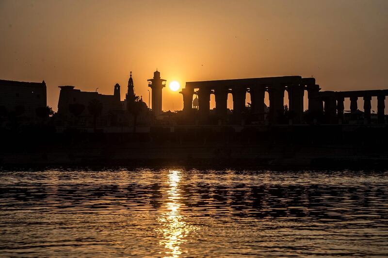 (FILES) This file photo taken on September 10, 2017 shows the sun rising behind the Luxor Temple and the River Nile in the southern Egyptian town of Luxor. 
Sun-choking debris cast off by volcanoes more than 2,000 years ago starved headwaters feeding the Nile river and hastened the downfall of ancient Egypt's last kingdom, researchers said Tuesday. / AFP PHOTO / KHALED DESOUKI