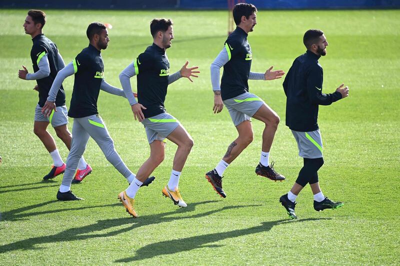 Atletico Madrid players warm-up at training. AFP