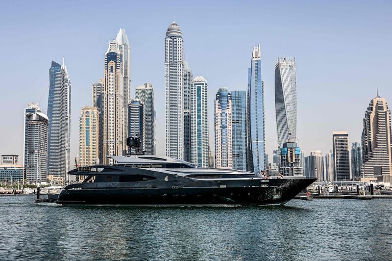 A luxury yacht sails past the equally opulent Dubai Marina. AFP