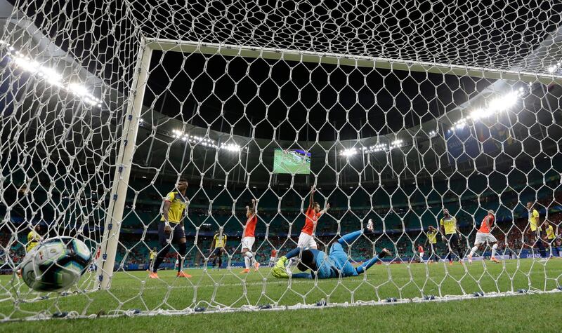 Ecuador goalkeeper Alexander Dominguez fails to stop a shot by Chile's Alexis Sanchez. AP Photo