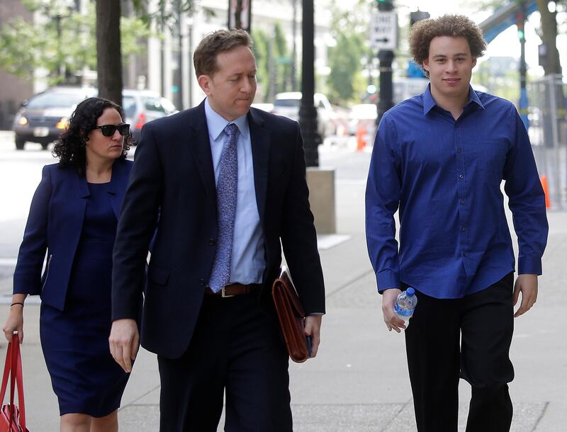 (FILES) In this file photo taken on August 14, 2017, Marcus Hutchins (R), the British cyber security expert accused of creating and selling malware that steals banking passwords, arrives with his lawyers Marcia Homann (L) and Brian Klein (C) at US Federal Courthouse in Milwaukee, Wisconsin.  A British computer security researcher once hailed as a "hero" for helping stem a ransomware outbreak and later accused of creating malware to attack the banking system said Friday, April 19, 2019 he pleaded guilty to US criminal charges. Marcus Hutchins, whose arrest in 2017 stunned the computer security community, acknowledged in a statement pleading guilty to criminal charges linked to his activity in 2014 and 2015.  / AFP / Joshua Lott
