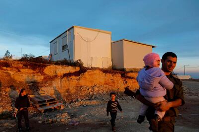 Men and children play in the Kida outpost near the Israeli Shilo settlement on January 27, 2020 near the Palestinian city of Nablus in the occupied West Bank. The Palestinians urged world powers to reject Donald Trump's peace plan, which they said president Mahmud Abbas had refused to discuss with his US counterpart despite several outreaches. Trump is due to unveil his proposal for Middle East peace this week in Washington, where he is scheduled to meet Israeli Prime Minister Benjamin Netanyahu and opposition leader Benny Gantz.
 / AFP / MENAHEM KAHANA
