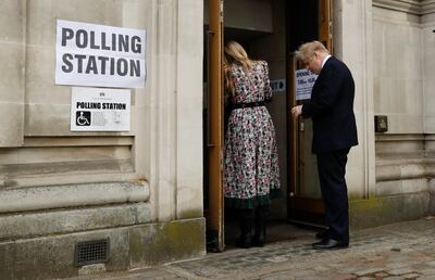 Former British Prime Minister Boris Johnson arrives at a polling station with his wife Carrie Symonds to cast his vote in local council elections in London. AP 