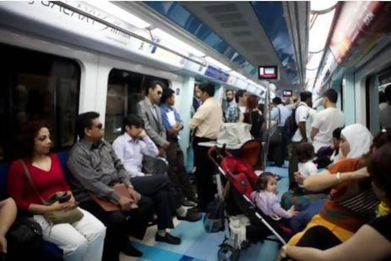 Commuters take the Dubai Metro on Car Free Day. Razan Alzayani / The National