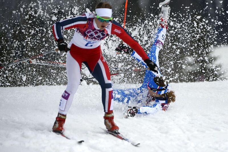 Italy's Greta Laurent falls as Norway's Ingvild Flugstad Oestberg skis past as they compete in the women's cross-country skiing individual sprint free quarter-finals at the Laura Cross-Country Ski and Biathlon Center in Rosa Khutor on Tuesday. Pierre-Philippe Marcou / AFP