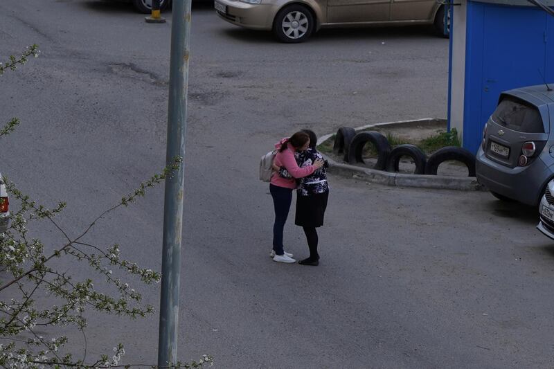 A parent embraces her child after a deadly shooting at School No. 175 in Kazan. Courtesy of Max Zareckiy via Reuters