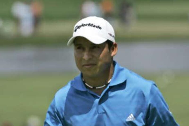 Andres Romero, of Argentina, waves to the gallery after putting on the 17th green during the third round of the 90th PGA Championship golf tournament.