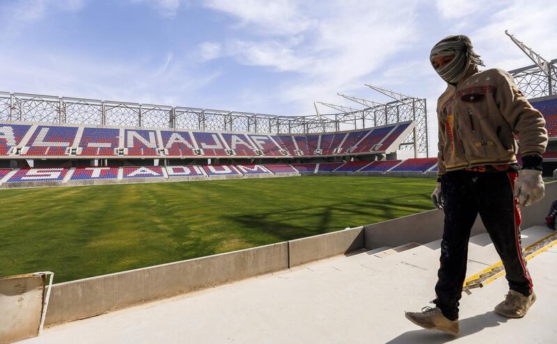 A man walks near the pitch in Najaf International Stadium in Iraq's central shrine city on February 8, 2018.
Iraq hopes that hosting Gulf football teams, renovating its crumbling stadiums and banning weapons at matches will persuade FIFA to lift a ban on international matches, according to its sports and youth minister.
Iraq has not hosted international matches since 1990, following its invasion of Kuwait under dictator Saddam Hussein and the ensuing international embargo.  / AFP PHOTO / Haidar HAMDANI