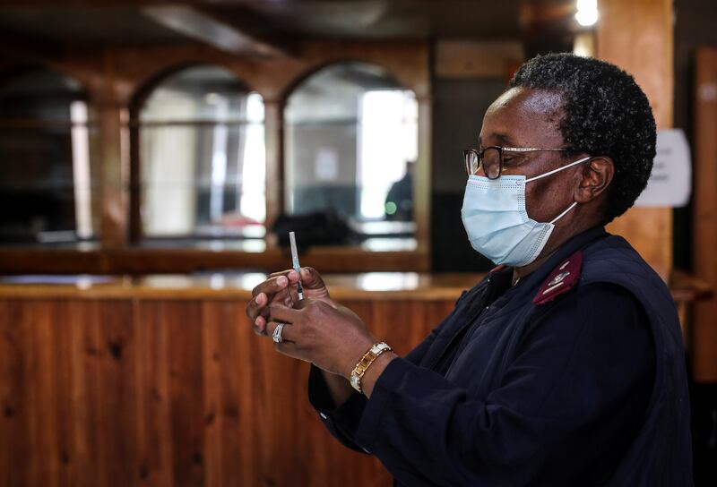 A health care worker prepares a dose of the Pfizer vaccine in Johannesburg, South Africa. Reuters