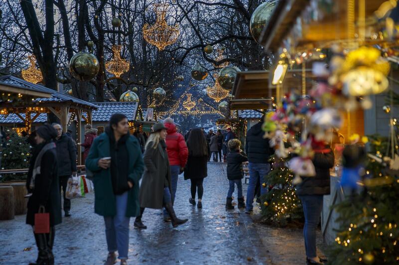 Visitors walk at the Christmas market 'Noel aux Bastinos' in the Parc des Bastions, in Geneva, Switzerland.  EPA