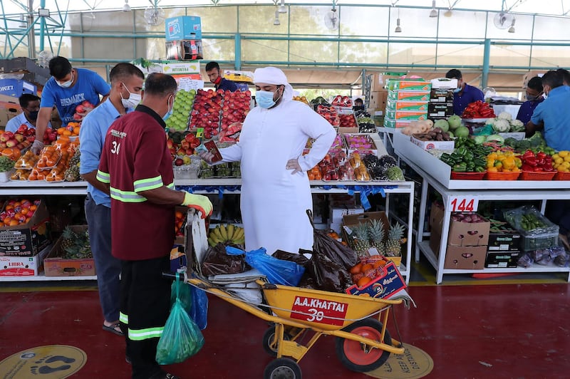 DUBAI, UNITED ARAB EMIRATES , May 5 – 2020 :- People wearing protective face mask at the Al Awir fruit & vegetable market in Dubai. UAE government ease the coronavirus restriction for the residents around the country. (Pawan Singh / The National) For News/Standalone/Online/Stock