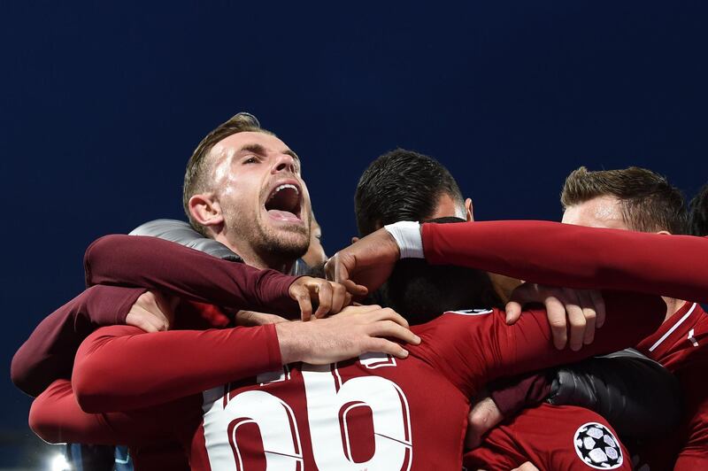 Jordan Henderson celebrates after Liverpool's Dutch midfielder Georginio Wijnaldum scores their third goal. AFP