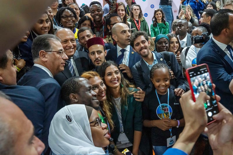 Sameh Shoukry, Cop27 president, centre left, poses for photos in the youth pavilion. AP