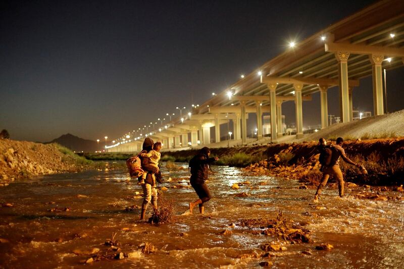 Migrants cross the Rio Bravo to turn themselves in to US Border Patrol agents to request for asylum in El Paso, Texas, as seen from Ciudad Juarez, Mexico. Reuters