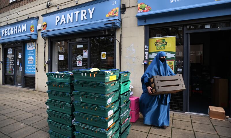 Staff with a new food delivery outside the Peckham Pantry in London.  Food banks are braced for a big rise in demand in the run up to Christmas.  EPA