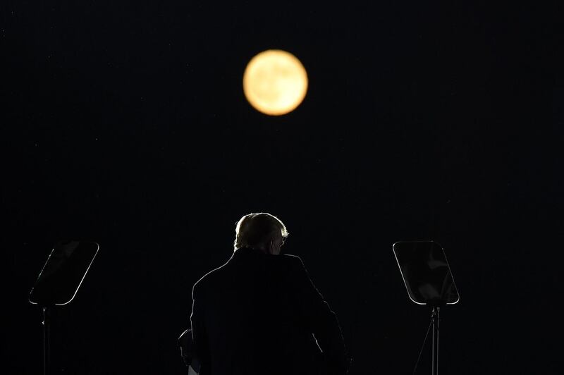 US President Donald Trump speaks as a full moon rises during a rally at Pittsburgh-Butler Regional Airport in Butler, Pennsylvania.  AFP