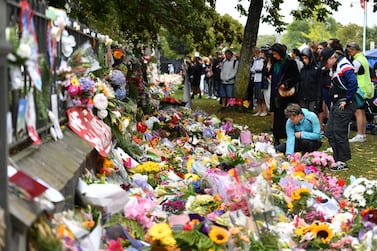 Members of the public place flowers at a makeshift memorial for the victims of the mosque mass murders at the Botanical Gardens in Christchurch, New Zealand. EPA